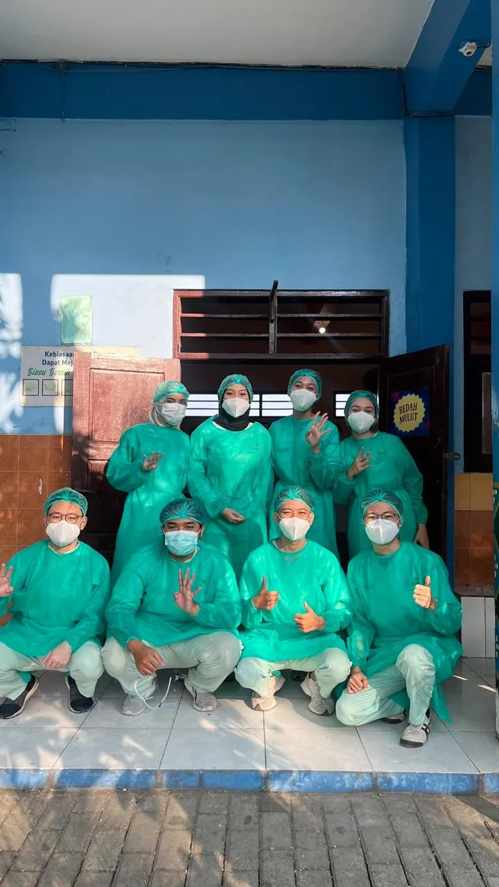 A group of Dentistry Charity volunteers in protective clothing outside the outreach venue.